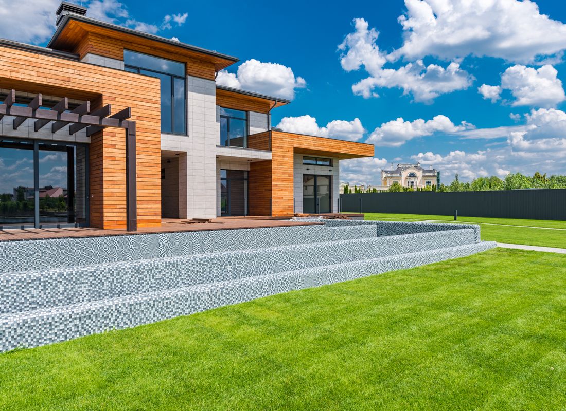 Contemporary home with panoramic windows and a green lawn