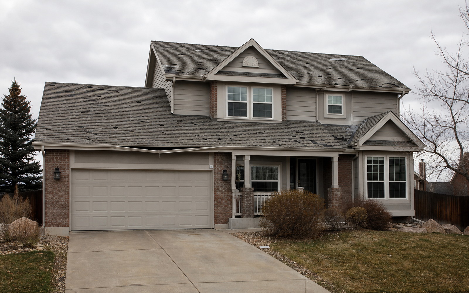 Storm-damaged roof before replacement