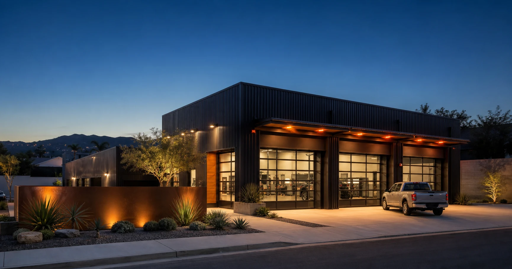 Modern collision repair studio exterior at blue hour