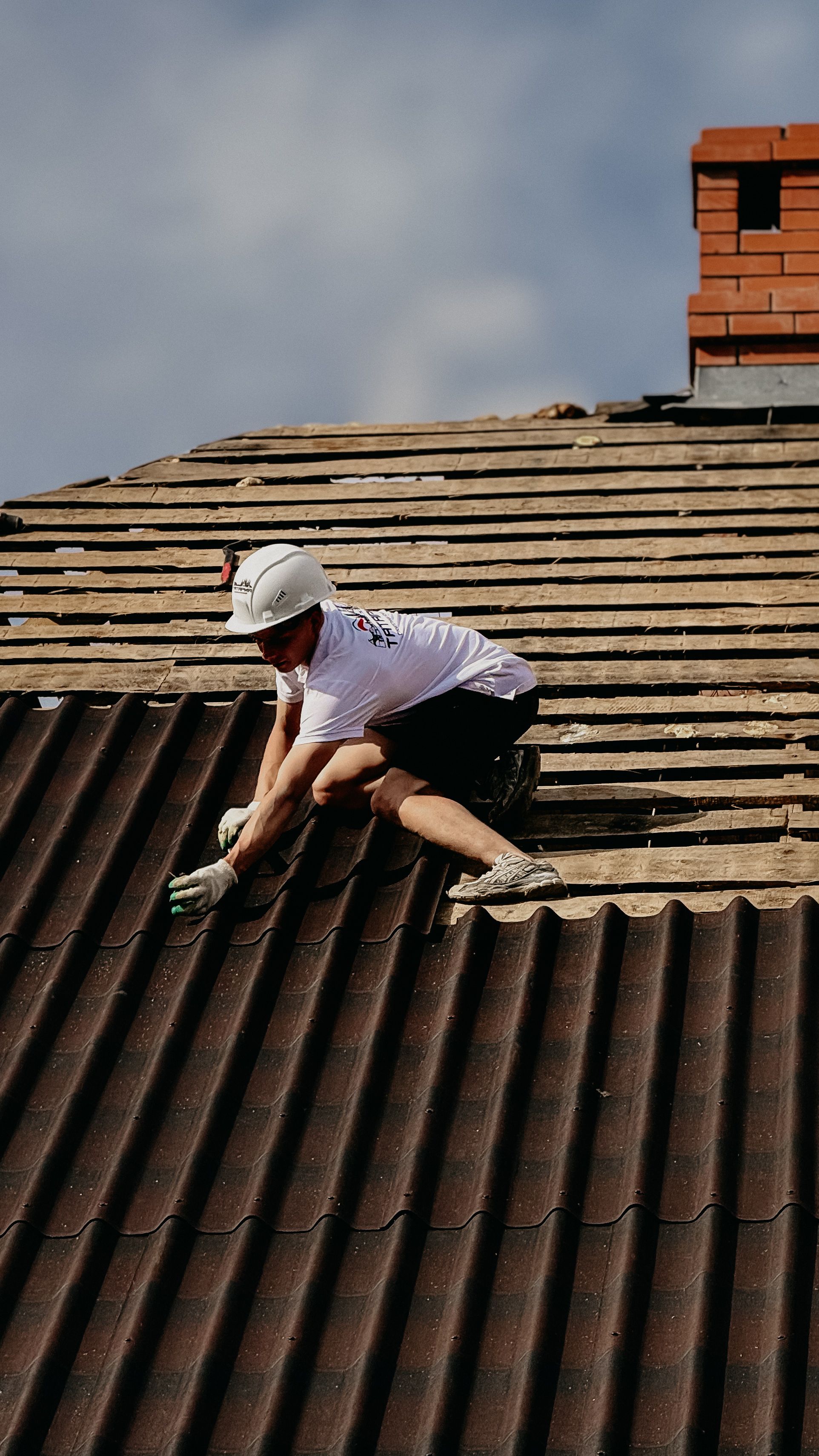 A roofing specialist repairing an existing roof