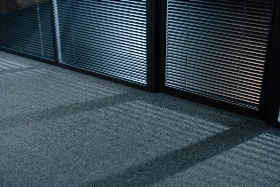 Sunlight through venetian blinds onto carpet