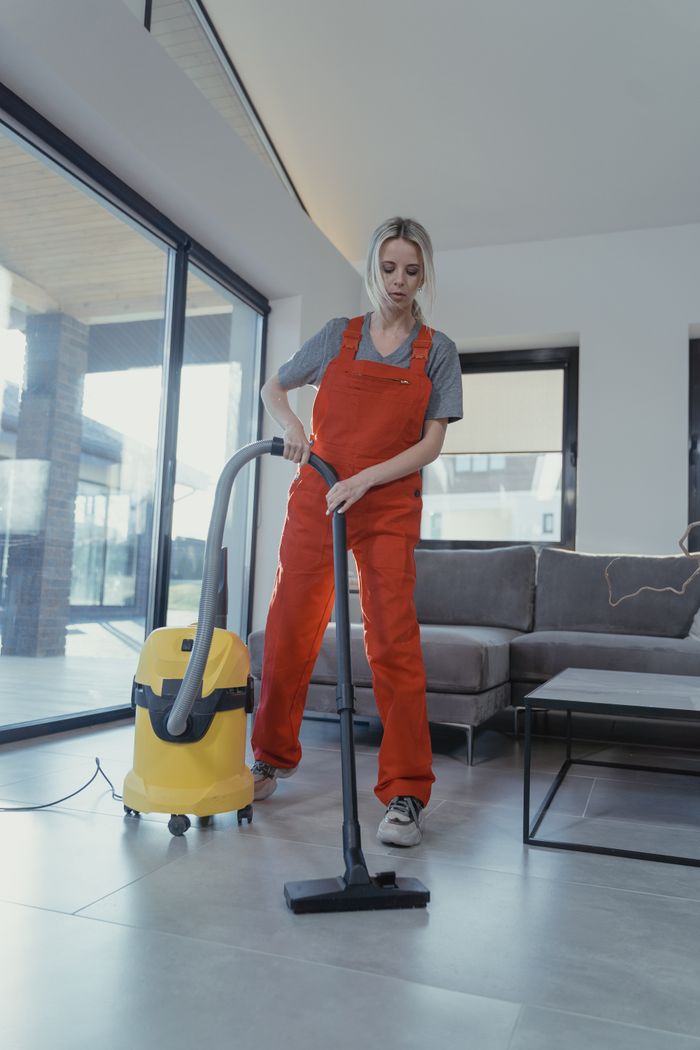 Cleaner vacuuming a living room