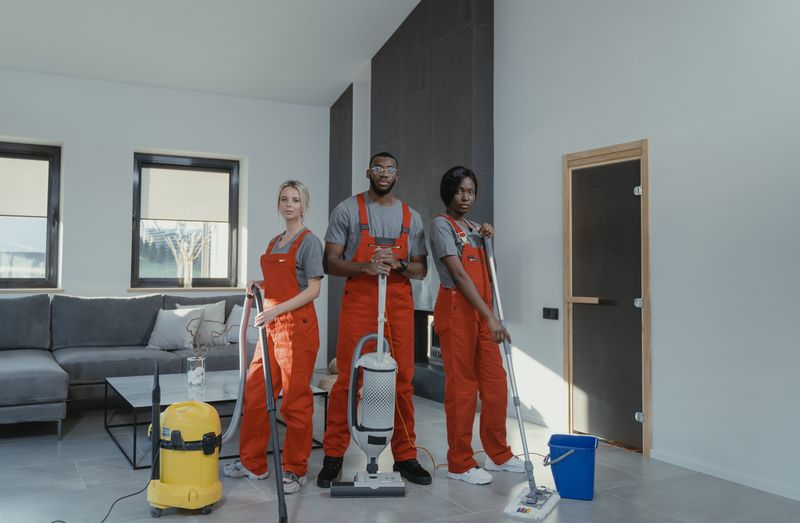 A uniformed cleaning team ready to work in a commercial space